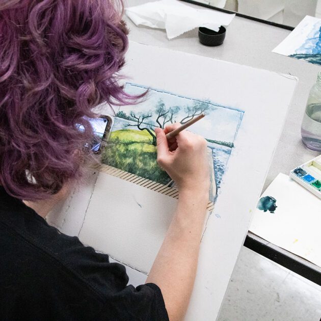 image of student painting with watercolor