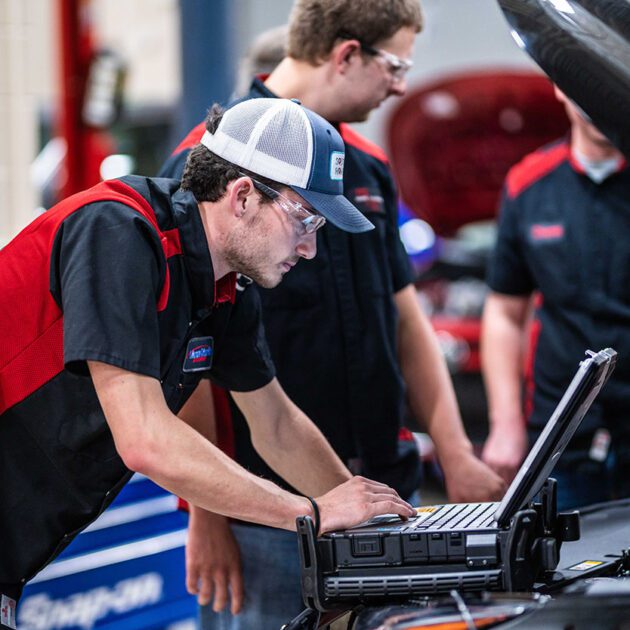 image of automotive student working on laptop