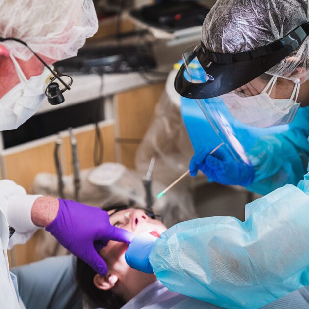 image of dental hygiene students working on patient