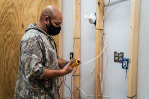 image of electrical student working with cables