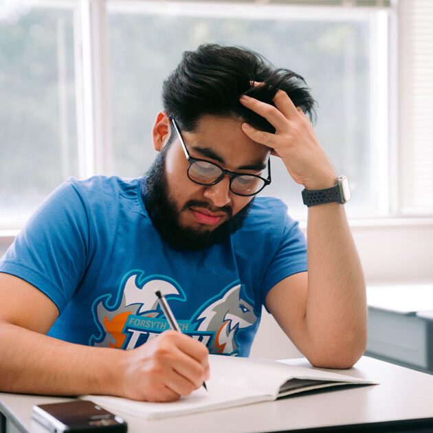 student writing in book
