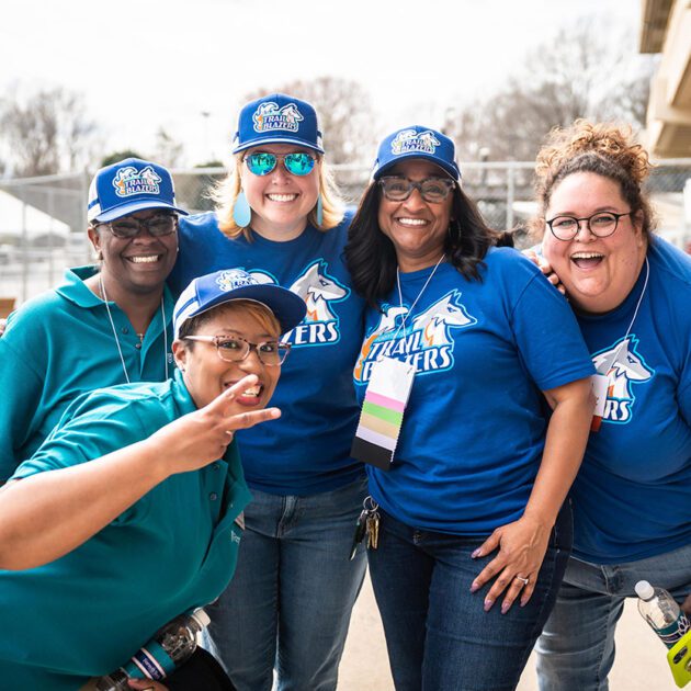 group of staff members posed wearing forsyth tech brand clothing