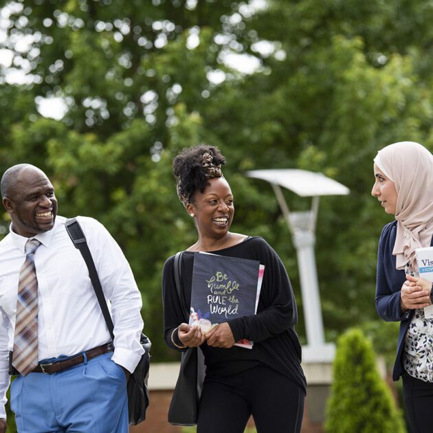 group of students speaking and walking outdoors