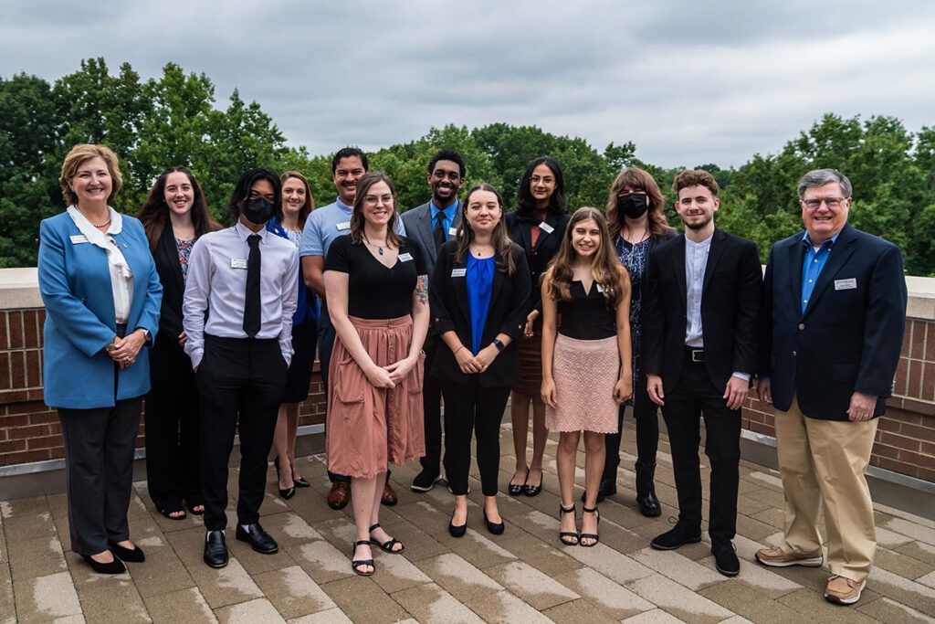 group of people standing alongside Dr. Spriggs outdoors