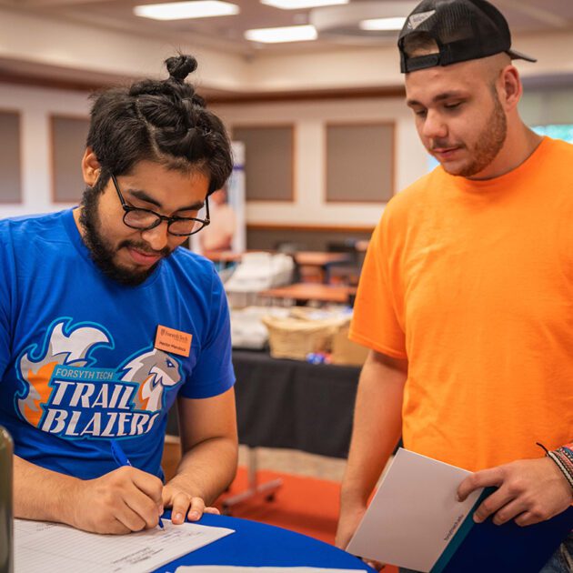 image of staff member helping student