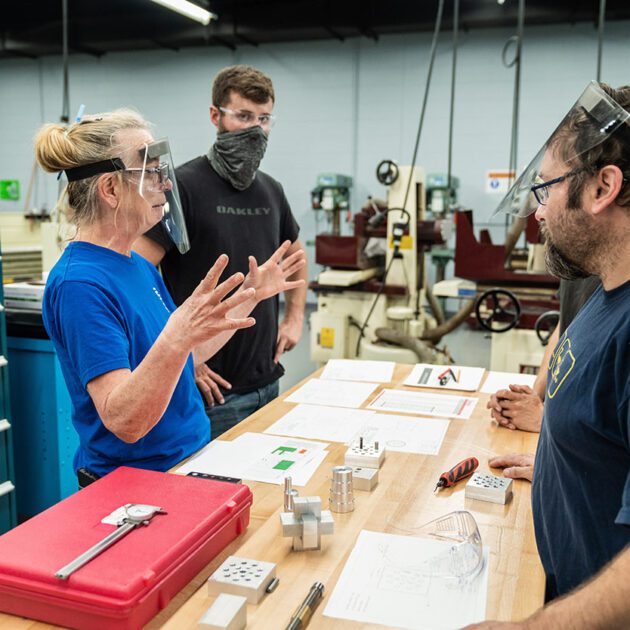 image of students using machining equipment