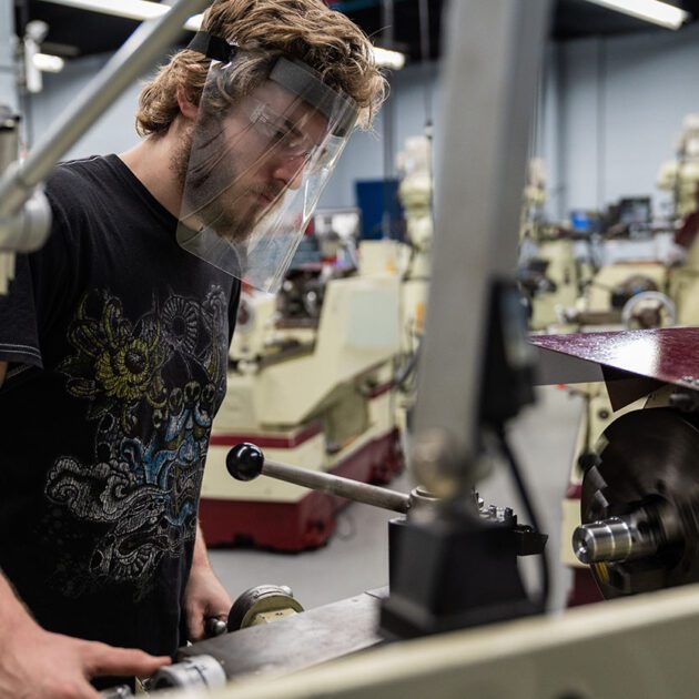 image of student using machining equipment