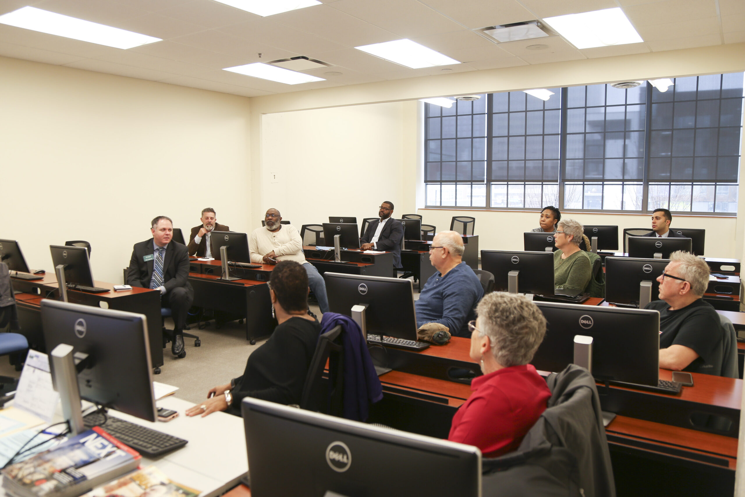 image of staff in a computer room speaking to each other