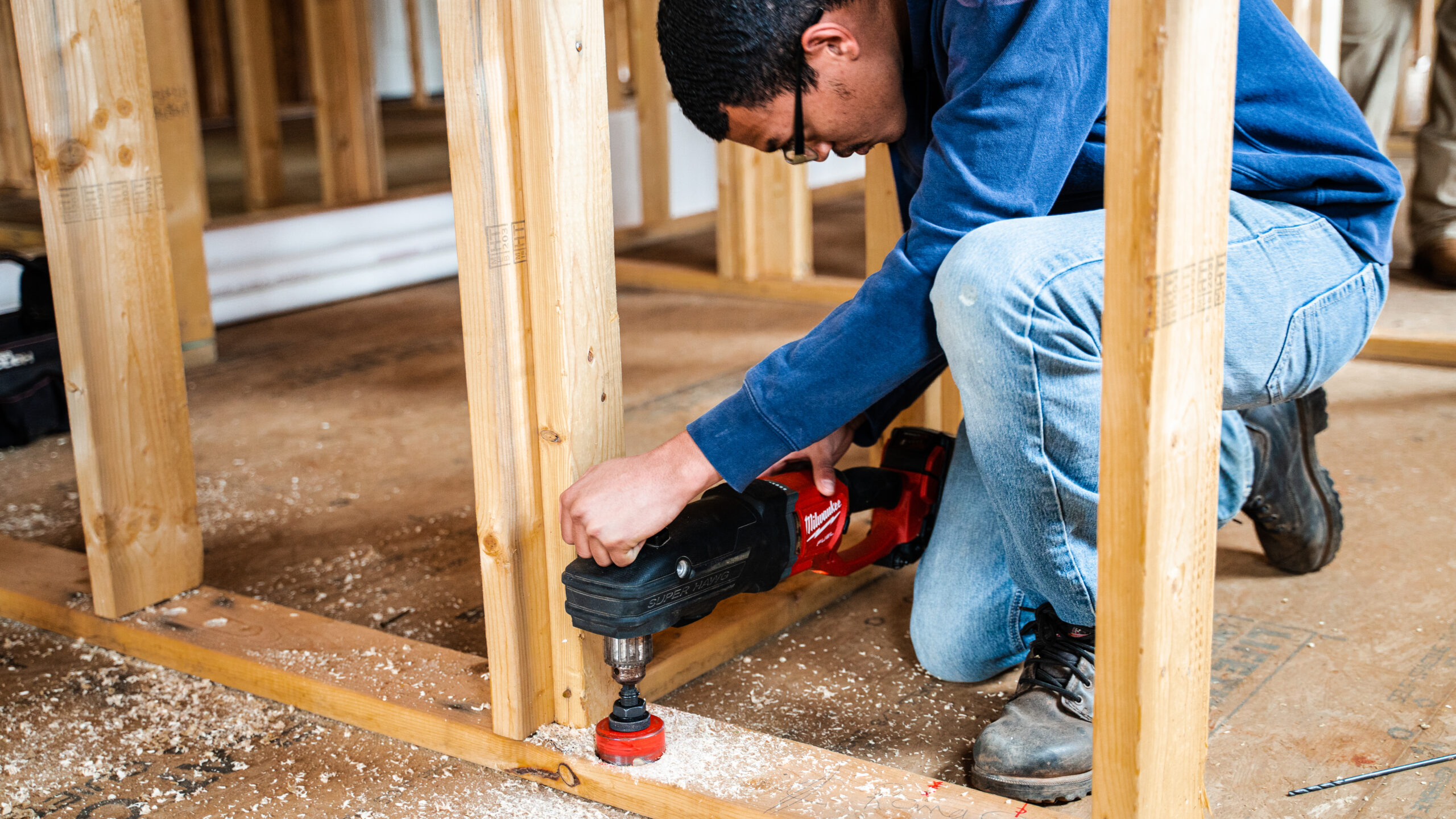 image of man using an electric sander