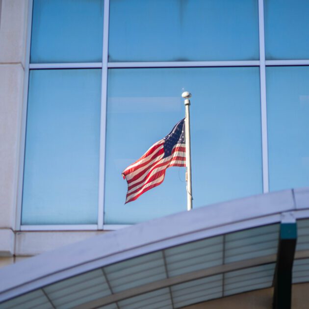 American flag seen outside of a window