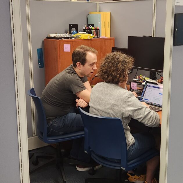 Tutor Working with student inside cubicle
