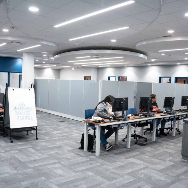 Image of students sitting at desks working on computers